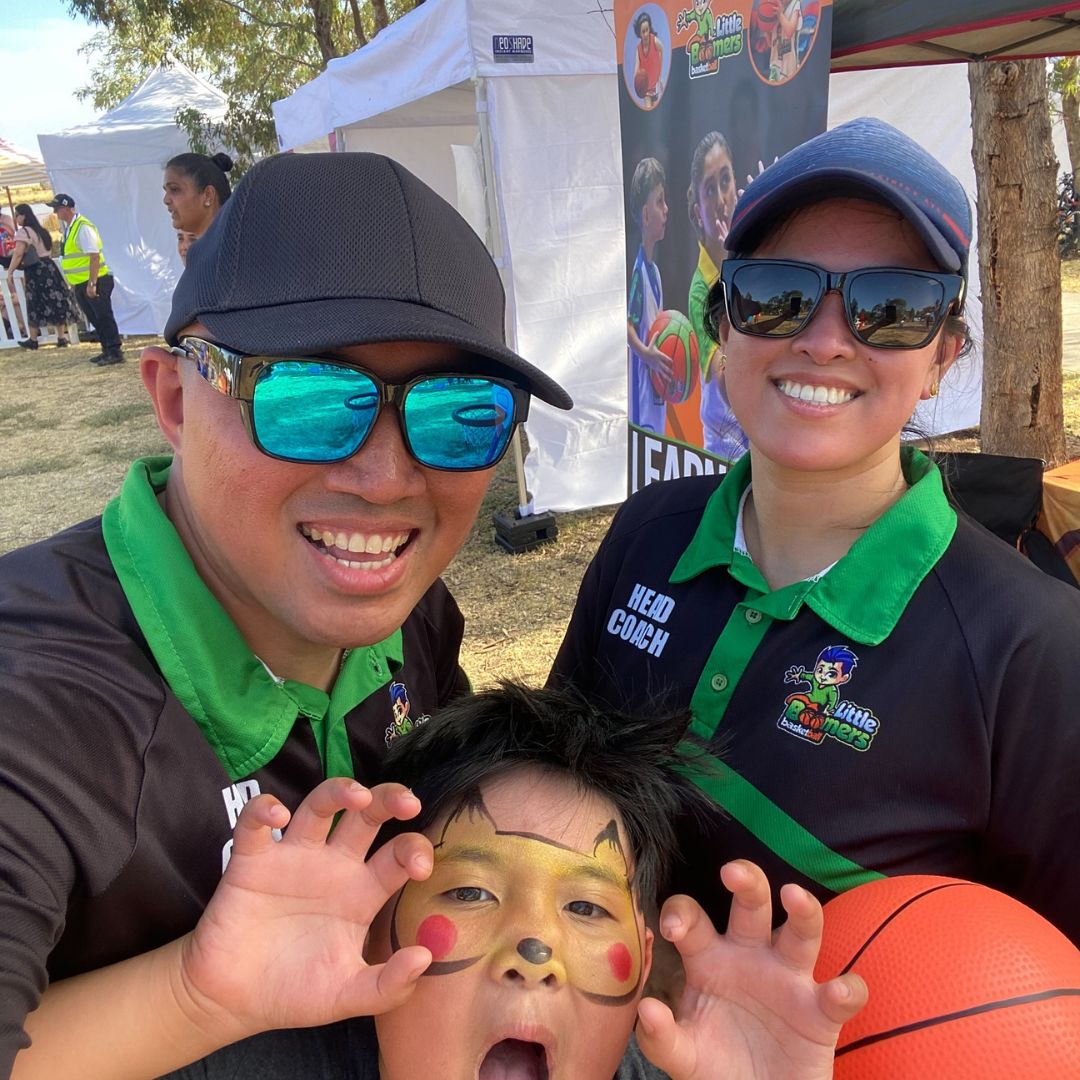 Miguel and Roxanne with their son at a Little Boomers Basketball community event